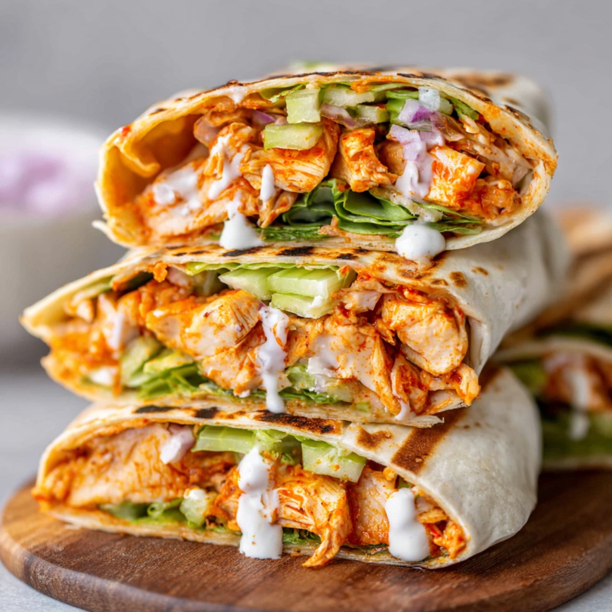 Homemade Buffalo Chicken Wraps filled with shredded chicken, lettuce, celery, and a drizzle of ranch dressing.
