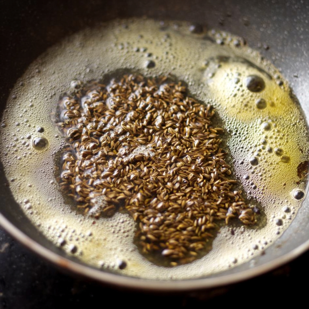 Add the cumin seeds and let them splutter for a few seconds. Toss in the tej patta and let it release its aroma.
