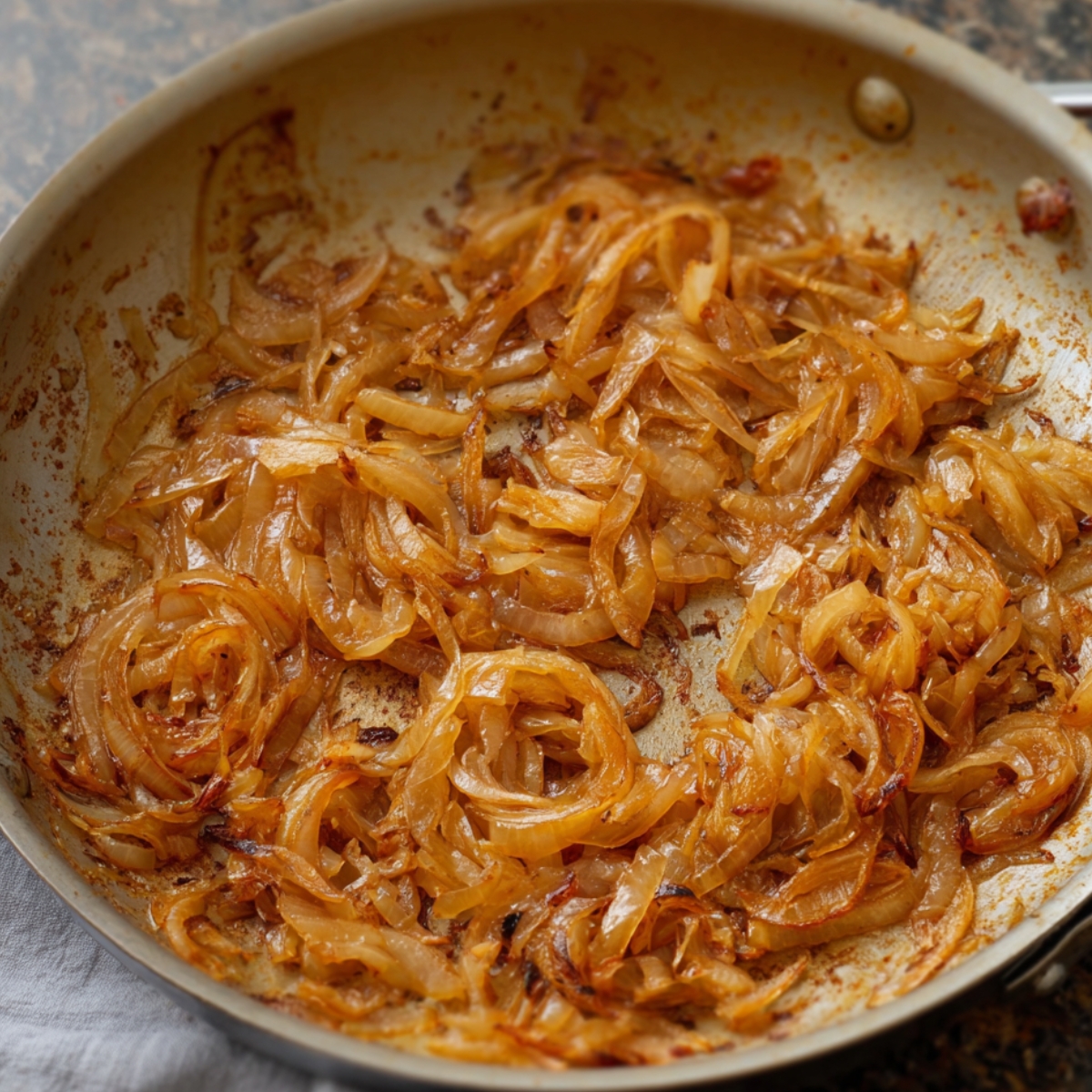 Seasoning and flavors being added to caramelized onions for a rich, savory base.