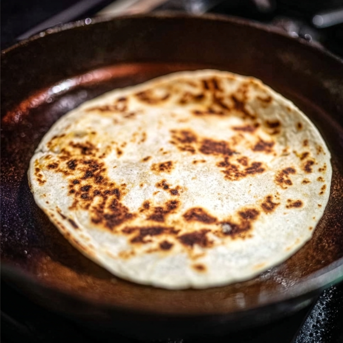 Tortilla being heated in a pan for a crispy shell for Big Mac Smash Burger Tacos.