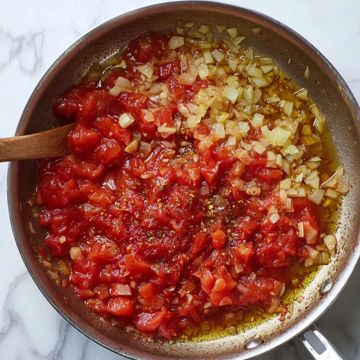 Tomato sauce, diced tomatoes, onions, and seasoning in a pan being combined to make salsa.
