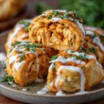 Buffalo Chicken Roll Ups drizzled with ranch and garnished with parsley.