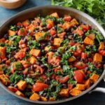 A colorful Sweet Potato Black Bean Skillet, black beans, tomatoes, and kale, creating a flavorful and hearty vegetable dish.